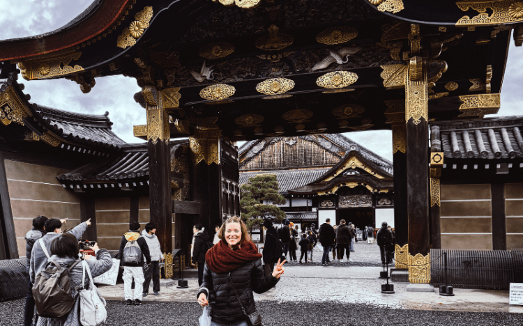 Image of a woman standing in front of Nijo Castle in Kyoto